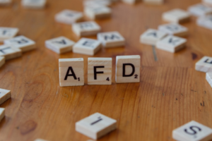 A wooden table topped with scrabble tiles spelling the word afd — Foto por Markus Winkler na Unsplash