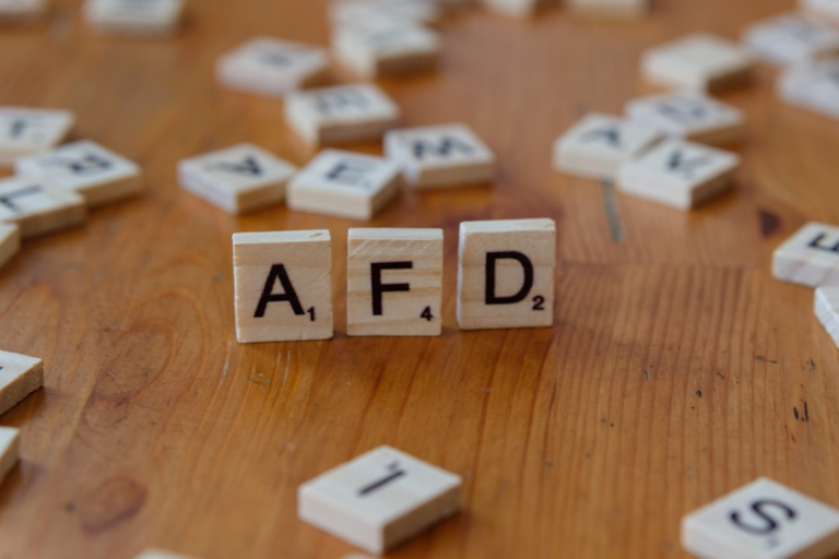 A wooden table topped with scrabble tiles spelling the word afd — Foto por Markus Winkler na Unsplash