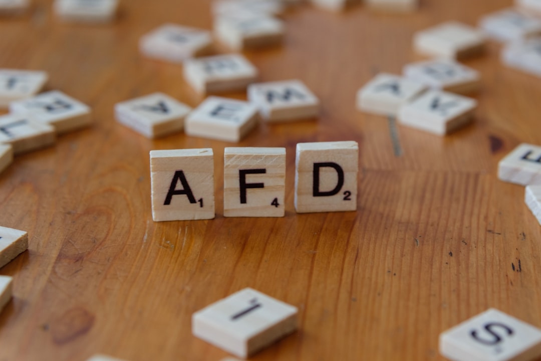 A wooden table topped with scrabble tiles spelling the word afd — Foto por Markus Winkler na Unsplash